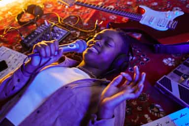 Singer with mic lying on carpet